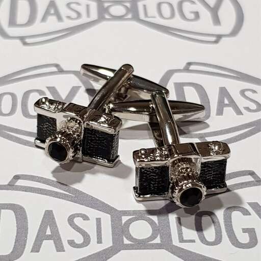 a couple of silver rings on top of a white surface.