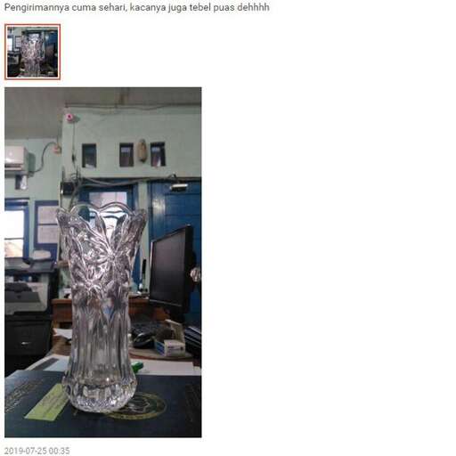 a glass vase sitting on top of a table.