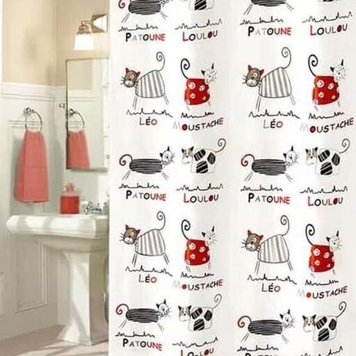 a bathroom with a cat shower curtain and toilet paper.