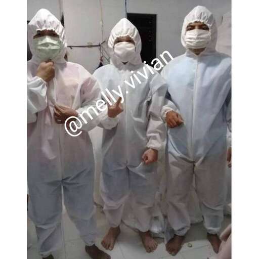 a group of doctors wearing surgical clothes and masks.