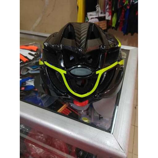 a helmet with a yellow strap and some other items in the front.