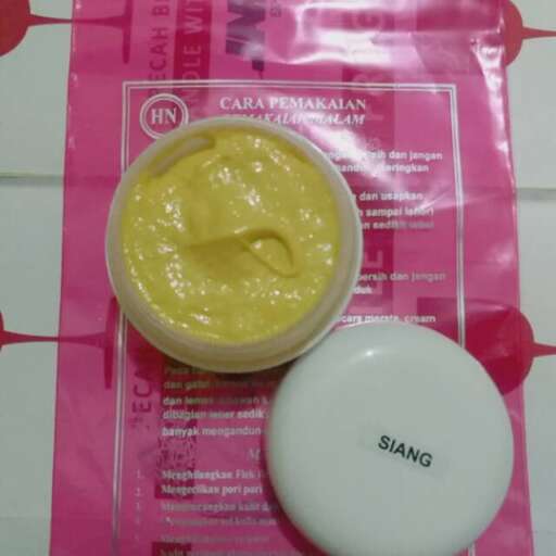 a plastic container of yellow mustard