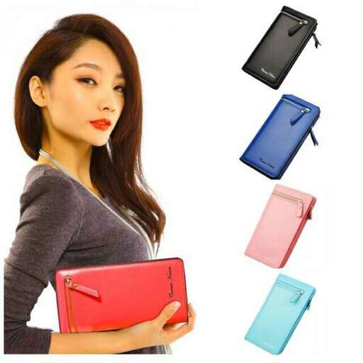a woman holding a red purse and a cell phone.
