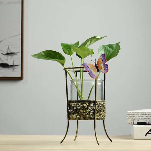 a small table with a vase with a flower in it.