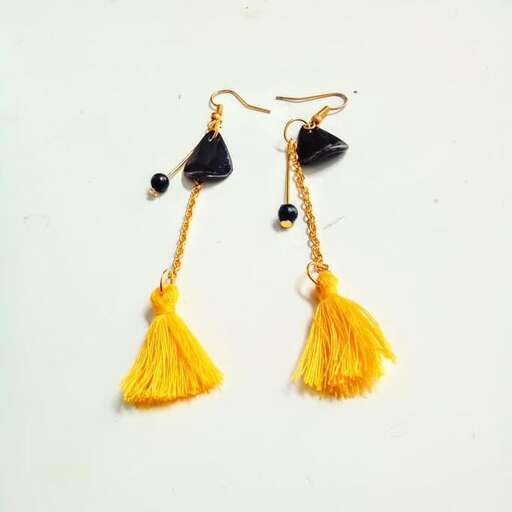 earrings made of gold and black glass and a black beaded necklace.