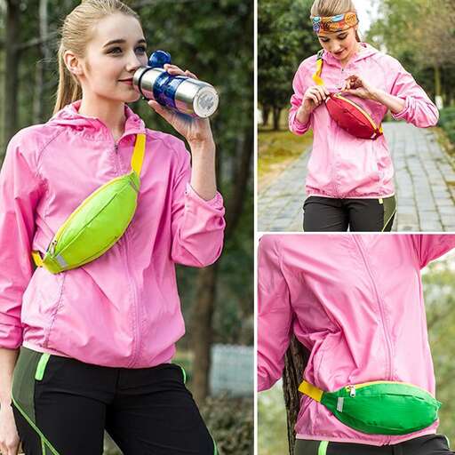 a woman in a pink jacket and green hat walking down a path.