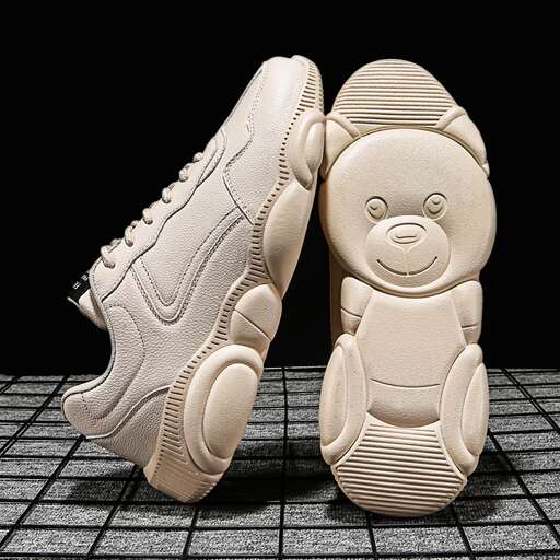a pair of shoes with a face on the sole.