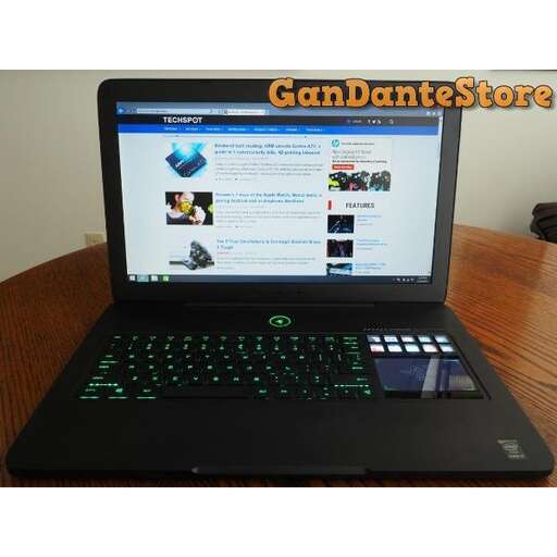 a laptop computer sitting on top of a wooden table.