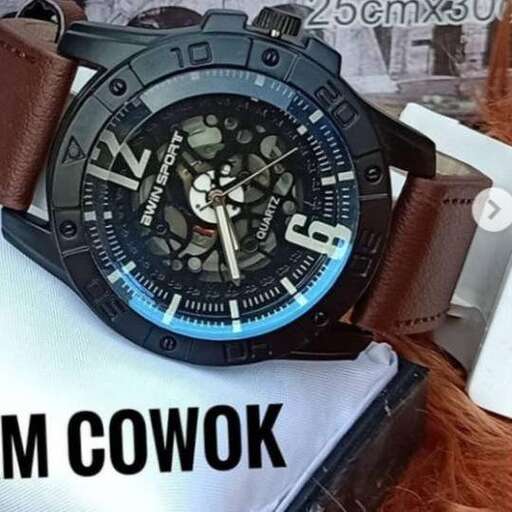 a watch with a face on it and a white watch on the back.