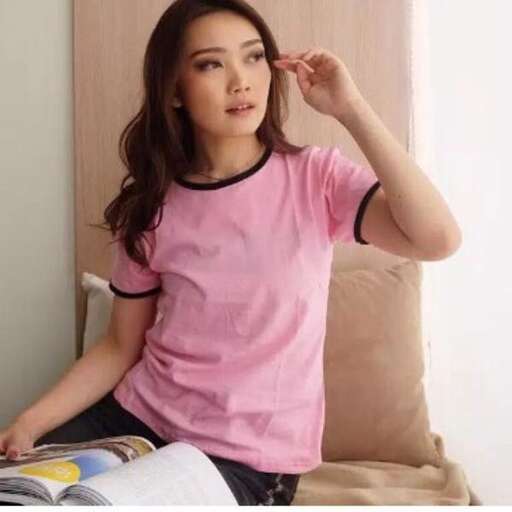 a woman sitting on a couch with a magazine in her hand