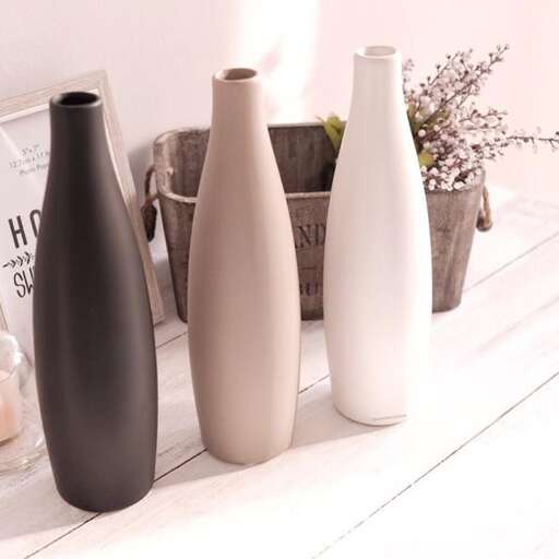 a group of vases sitting on a shelf.
