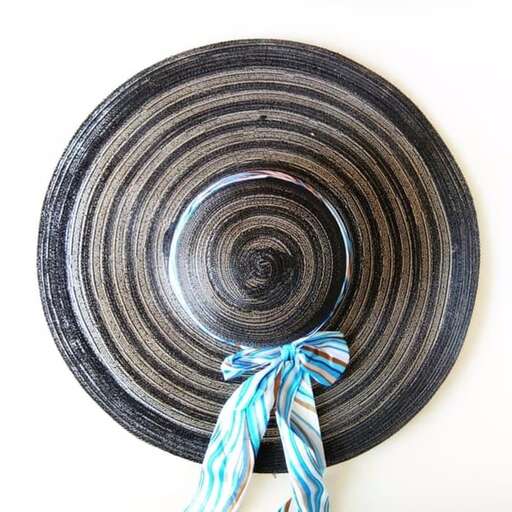 a hat made of straw and a blue ribbon.