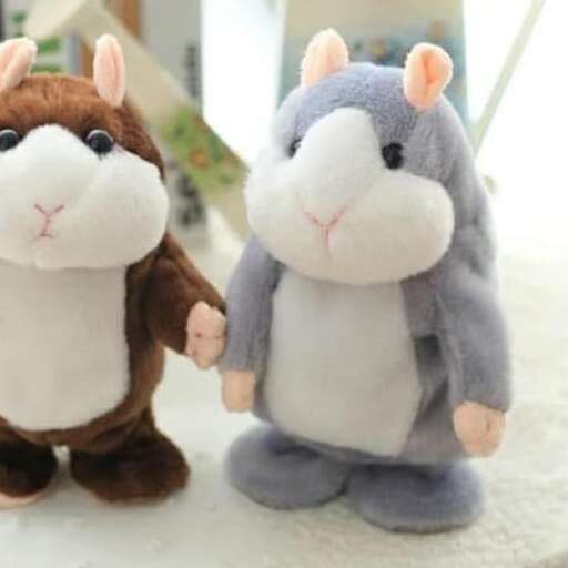 two stuffed animals are posed together on a table.