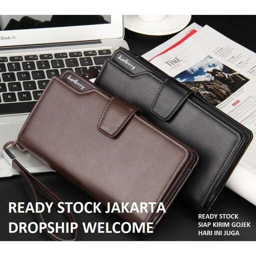 a brown leather wallet sitting next to a laptop.