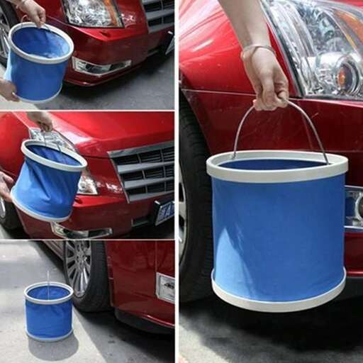 a bucket with a handle is attached to the front of a car.