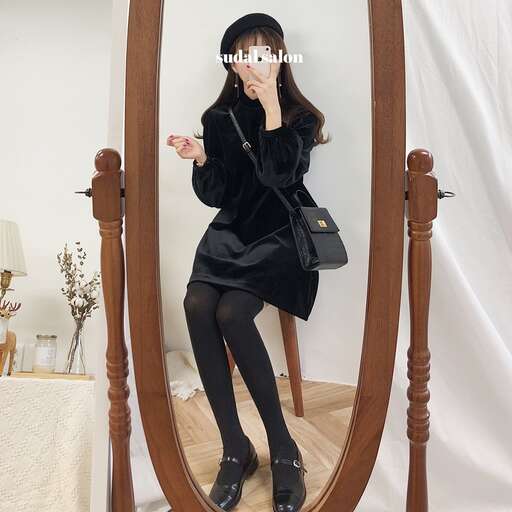 a woman sitting on a chair in front of a mirror.