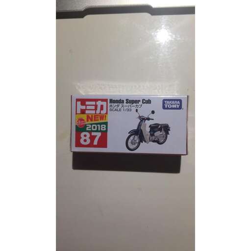 a sign on a wall with a picture of a motorcycle.