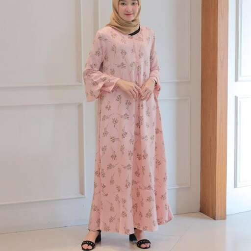 a young woman in a pink dress standing on a floor.