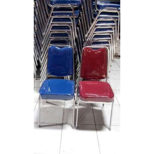 a row of red and blue chairs sitting next to each other.