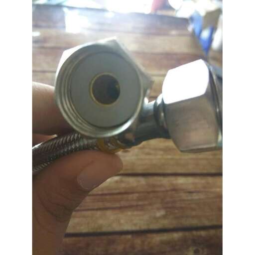 a person holding a flashlight with a camera in their hand.