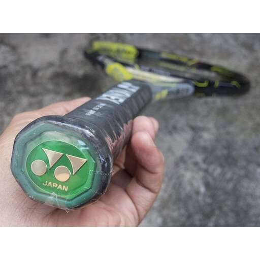 a close up of a person holding a tennis racket