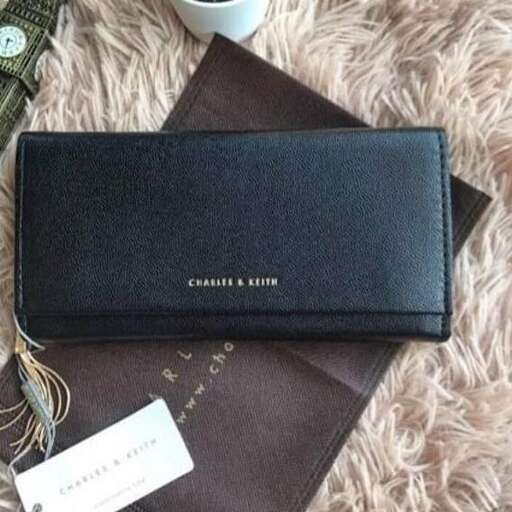 a black leather wallet with a silver zipper and a brown wallet.
