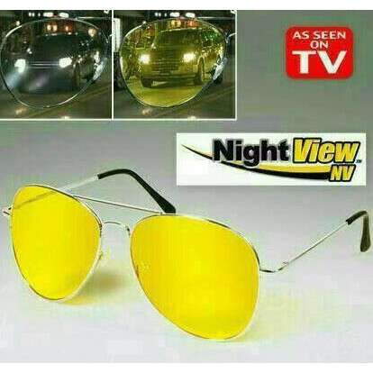 a pair of yellow glasses with a tv in the background