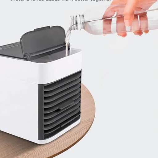 a hand pouring water into a toaster.
