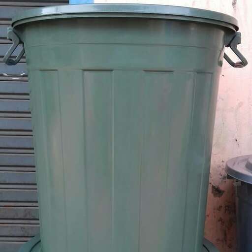 a large green bucket with a lid.