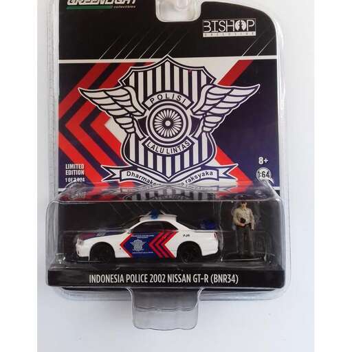 a toy car is sitting on a white surface.