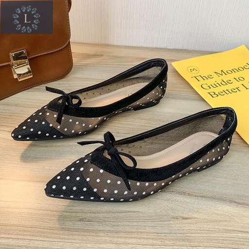 a pair of black and white polka dot slippers.