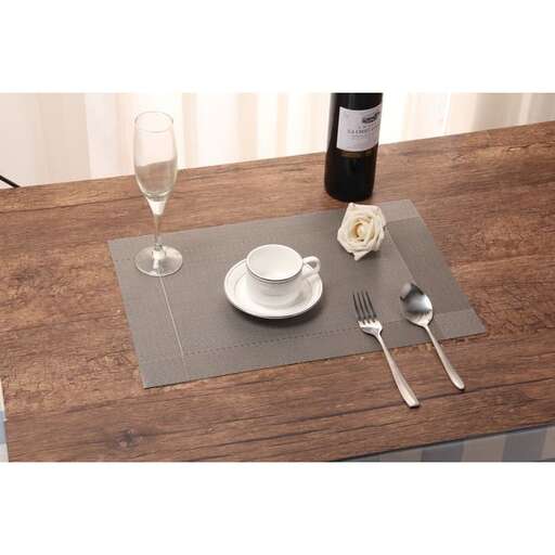 a place mat with a glass of wine and a fork.