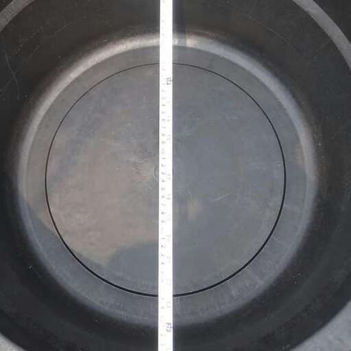 a large black bowl with a white line on it.