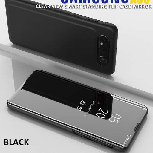 a black cell phone sitting on a shelf.