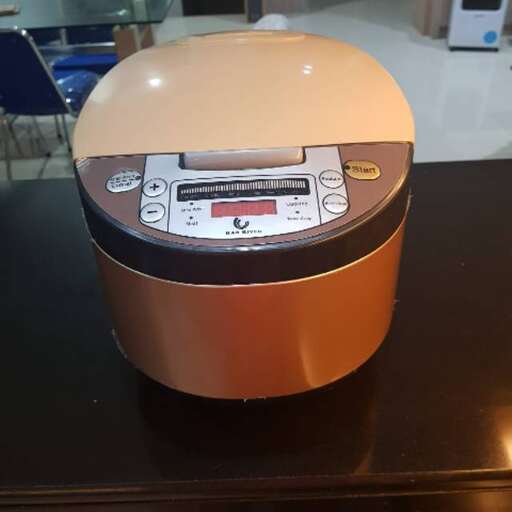 a close up of a orange and black appliance on a table