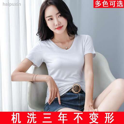 young woman in white t - shirt sitting in chair