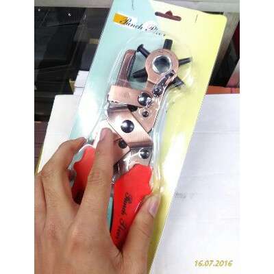 a hand holding a pair of scissors in a case.