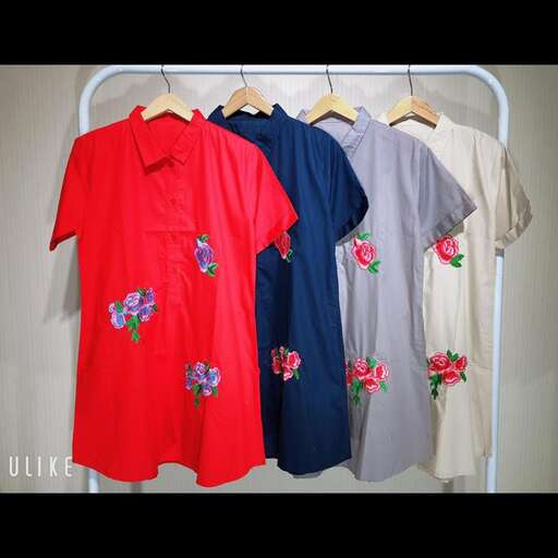 a rack of shirts with flowers on them.