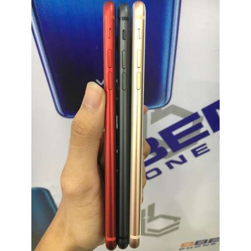 a hand holding a stack of cell phones.