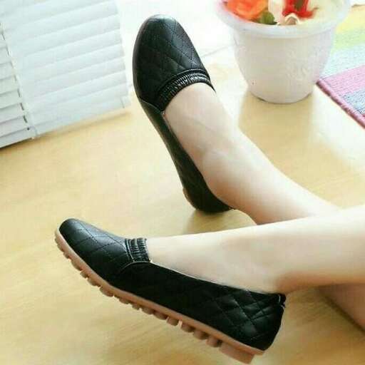 a woman wearing black shoes with white stockings and black shoes.