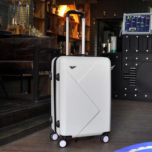 a suitcase sitting on a wooden floor in a room.