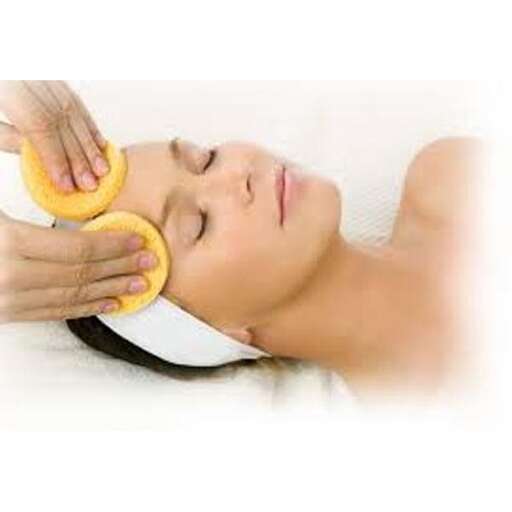 a woman is laying down and putting a ring on her nose.