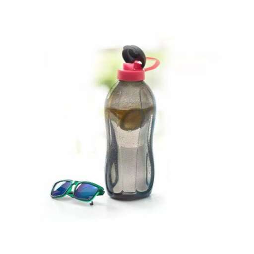 a bottle with a glass and a green flip flop.