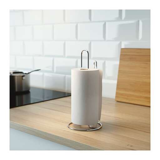 a white ceramic candle holder with a white paper towel holder.