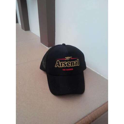 a black baseball cap sitting on a counter.