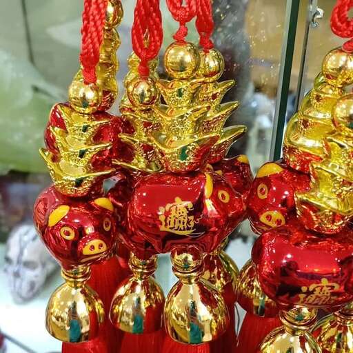 a red christmas tree with gold ornaments.