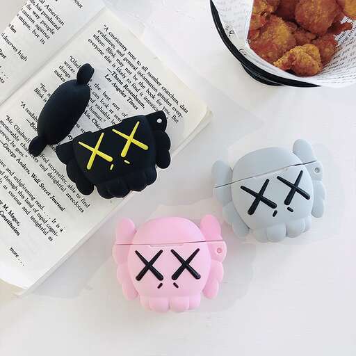 a table topped with two small stuffed animals and a bowl of food.