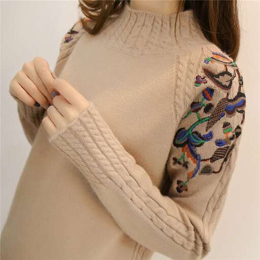 handmade sweater with a colorful design in the middle.