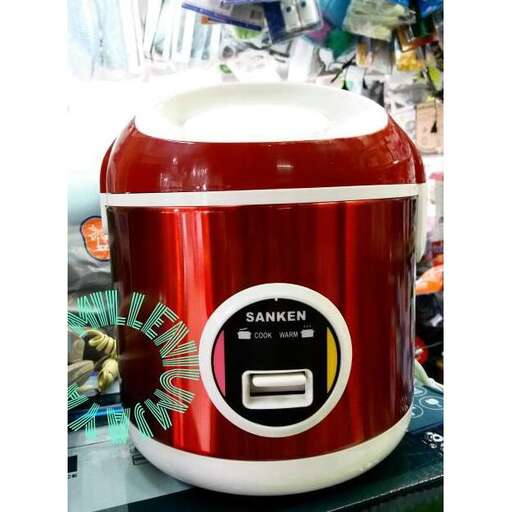 a red and white crock pot sitting on top of a table.