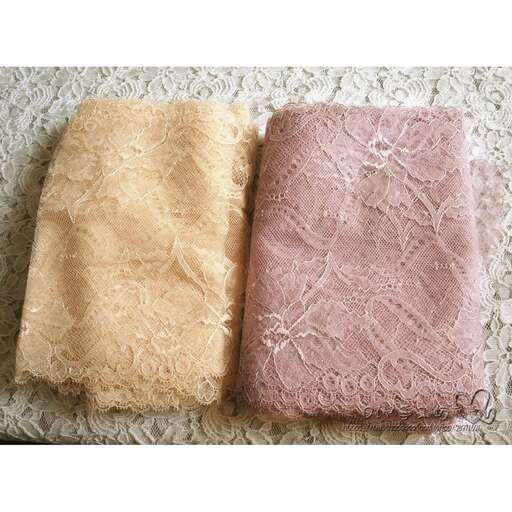 two pink and yellow pillows in a cream colored fabric.